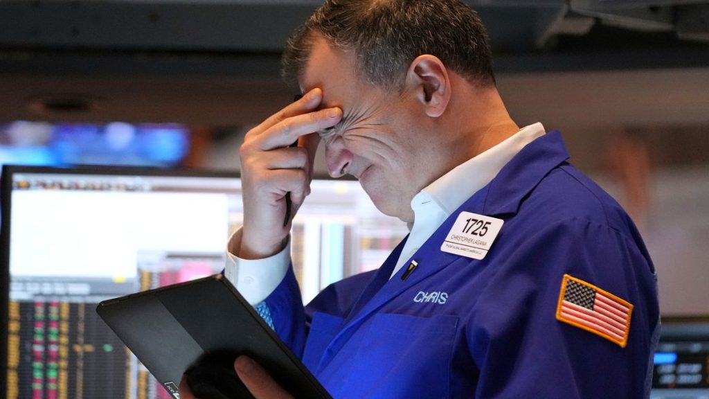 A person works on the floor at the New York Stock Exchange in New York, Monday, March 31, 2025.