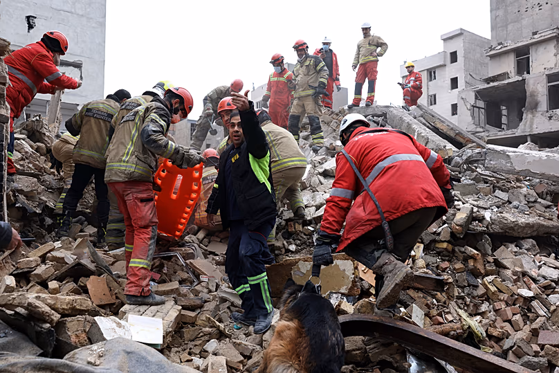 Des secouristes recherchent des survivants dans les décombres après une grève dans le sud de Téhéran, le 13 mars 2026.