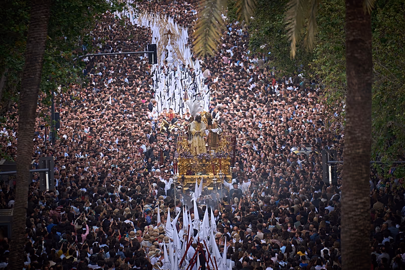 Des fidèles regardent une procession de la Semaine Sainte des pénitents de la confrérie San Gonzalo à Séville, en Espagne, le 14 avril 2025.