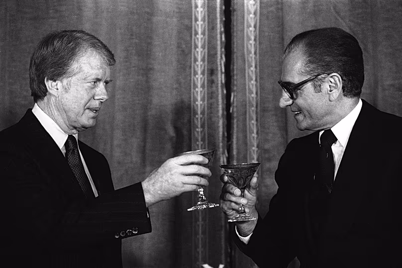 Le président américain Jimmy Carter porte un toast au Shah Mohammad Reza Pahlavi d'Iran lors d'un dîner de réveillon du Nouvel An au palais Niavaran à Téhéran, en décembre 1977.