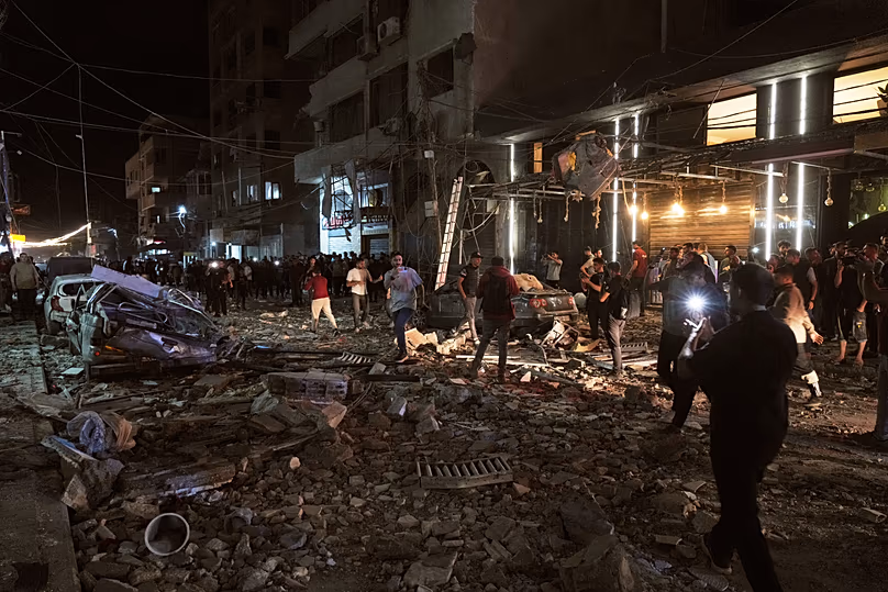 Des Palestiniens inspectent le site d'une frappe aérienne israélienne dans la ville de Gaza, le 26 mai 2026.