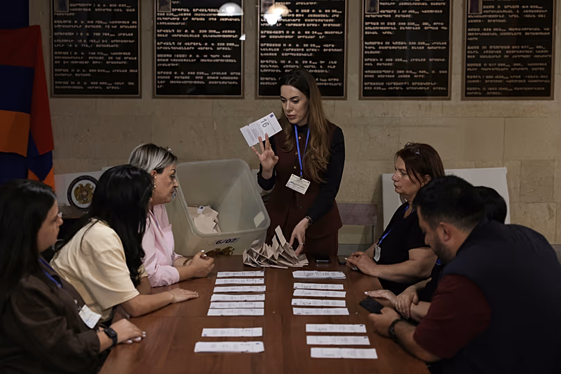 Les membres de la commission électorale se préparent à compter les bulletins de vote dans un bureau de vote lors des élections législatives à Erevan, le 7 juin 2026.