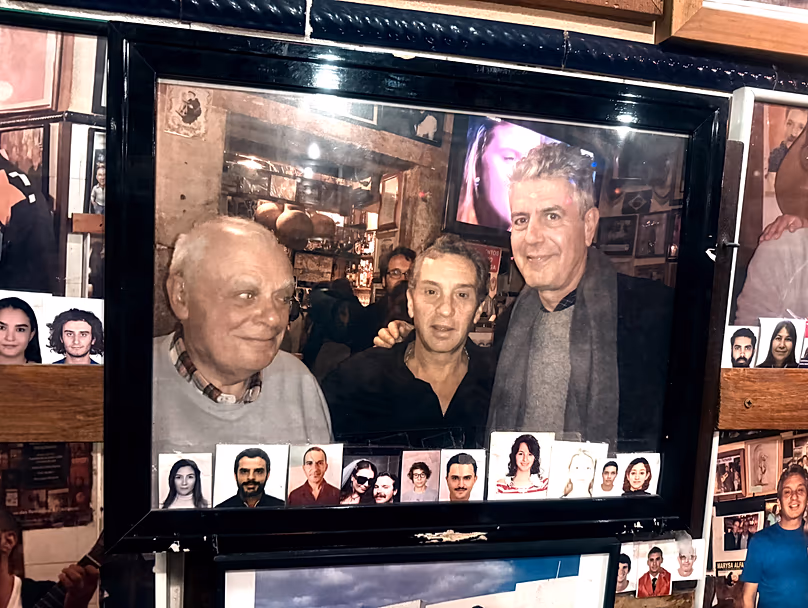The owner of the Tasca with Portuguese writer António Lobo Antunes and US chef and TV host Anthony Bourdain (photo displayed on site)