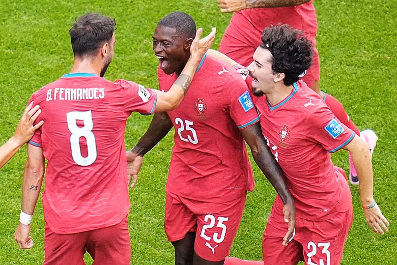 Portugal's Nuno Mendes celebrates with Fernandes and Vitinha after scoring during the World Cup Group K match against Uzbekistan in Houston, Tuesday, June 23, 2026
