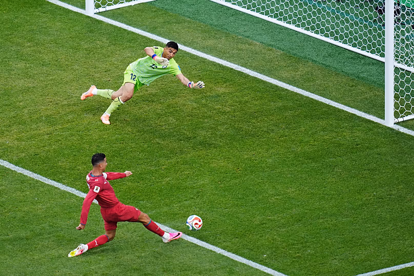Portugal's Cristiano Ronaldo misses a shot on goal as Uzbekistan goalkeeper Abduvohid Nematov defends during the World Cup Group K match in Houston, Tuesday, June 23, 2026