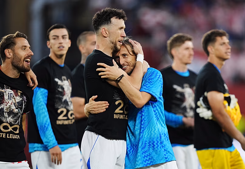 Croatia's Luka Modric celebrates with Ivan Perisic after defeating Panama as teammates wear shirts honouring his 200th appearance for Croatia, Toronto, Tuesday, June 23, 2026