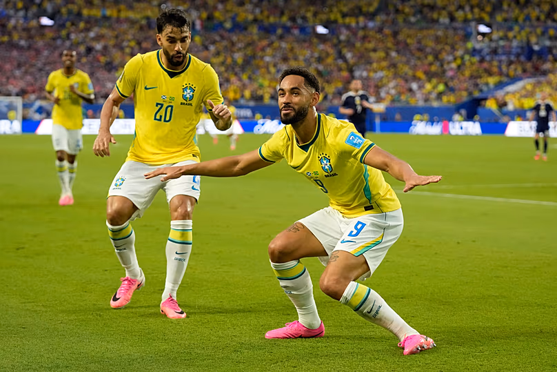 Brazil's Matheus Cunha celebrates with Lucas Paqueta after scoring the third goal during the World Cup Group C match against Scotland in Miami, Wednesday, June 24, 2026
