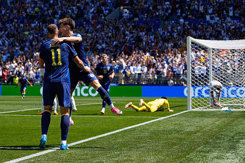 Bosnia's Edin Dzeko celebrates with Esmir Bajraktarevic after Qatar's Sultan Albrake scored an own goal during the World Cup Group B match in Seattle, Wednesday, June 24, 2026