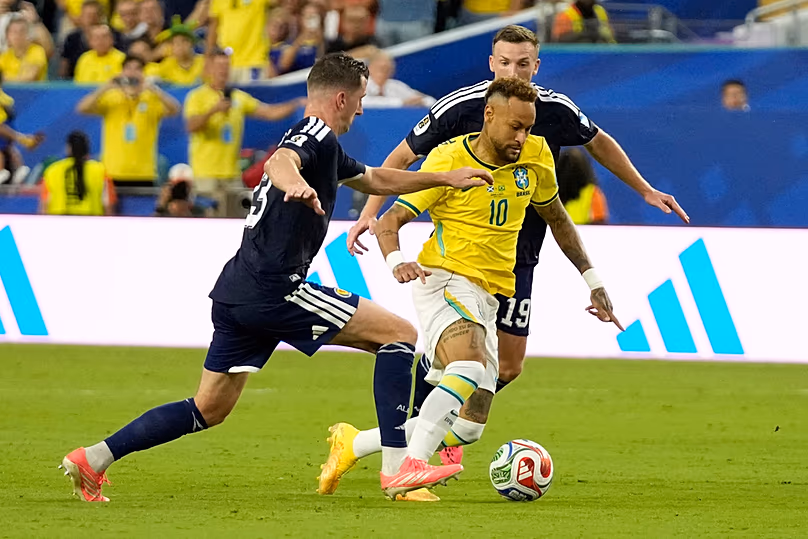 Brazil's Neymar challenges for the ball during the World Cup Group C match against Scotland in Miami Gardens, Florida, Wednesday, June 24, 2026