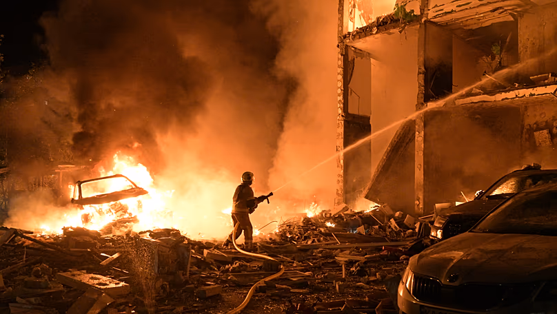 Emergency services personnel work to extinguish a fire following Russian missile attacks in Kyiv, 6 July, 2026