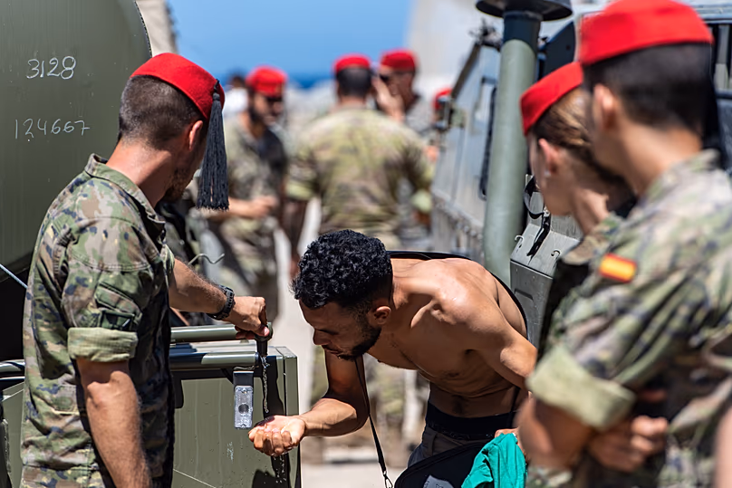 A migrant who has crossed from Morocco into Spain drinks water distributed by Spanish soldiers in the Spanish enclave of Ceuta, Sunday 2 August 2026.