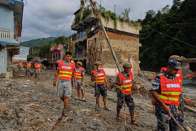 Des ouvriers déblayent les débris à la suite d'une crue soudaine dans la région de Devighat, dans le district de Nuwakot, au Népal, le 28 août 2026.