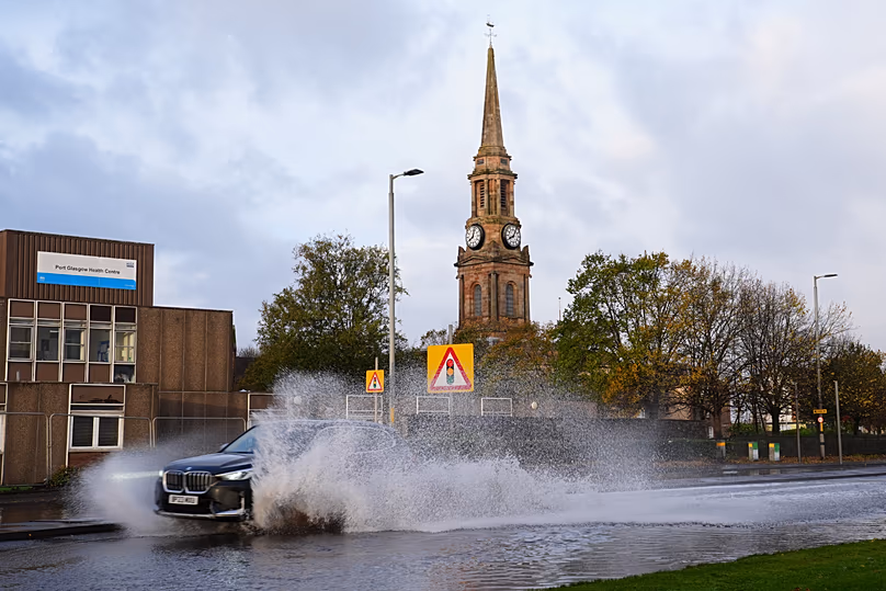 Une voiture roule sur l'A8 inondée à Port Glasgow, en Écosse, le dimanche 25 octobre 2026, après le passage de la tempête Boelo dans la région. (Jane Barlow/PA via AP)